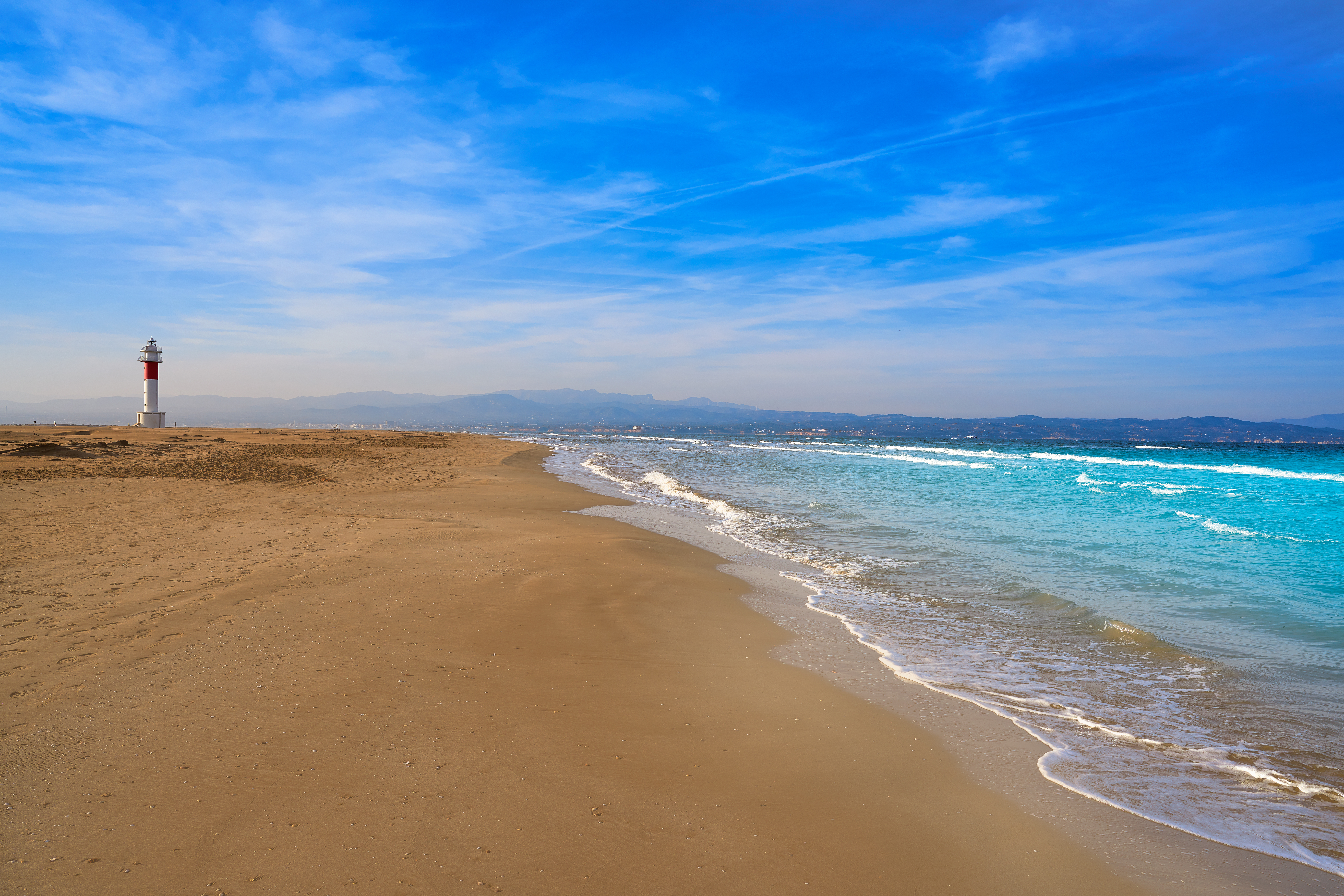 Punta del Fangar Lighthouse on a sandy Mediterranean beach in the Ebro Delta, Catalonia.
